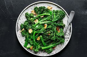 a plate of homemade broccolini cooked in olive oil and butter with salt and garlic and sprinkled with flaky salt