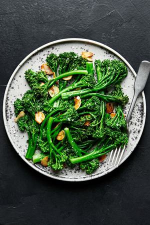 a plate of homemade broccolini cooked in olive oil and butter with salt and garlic and sprinkled with flaky salt