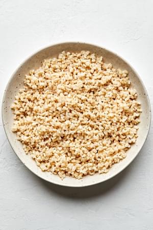 homemade brown rice cooked with water, salt and olive oil in a serving bowl