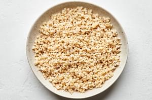 homemade brown rice cooked with water, salt and olive oil in a serving bowl