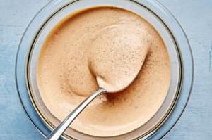 burger sauce in a bowl with a spoon made with mayo, ketchup, pickle juice, lime juice and spices