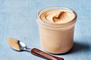Homemade burger sauce made with mayo, ketchup, spices, lime juice & pickle juice, in a jar next to a spoon full of sauce.