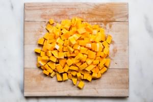 butternut squash diced on a cutting board