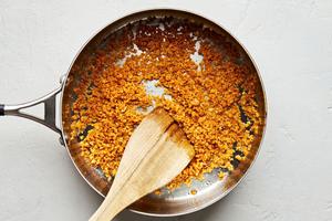 panko breadcrumbs being toasted in olive oil in a skillet for Caesar salad