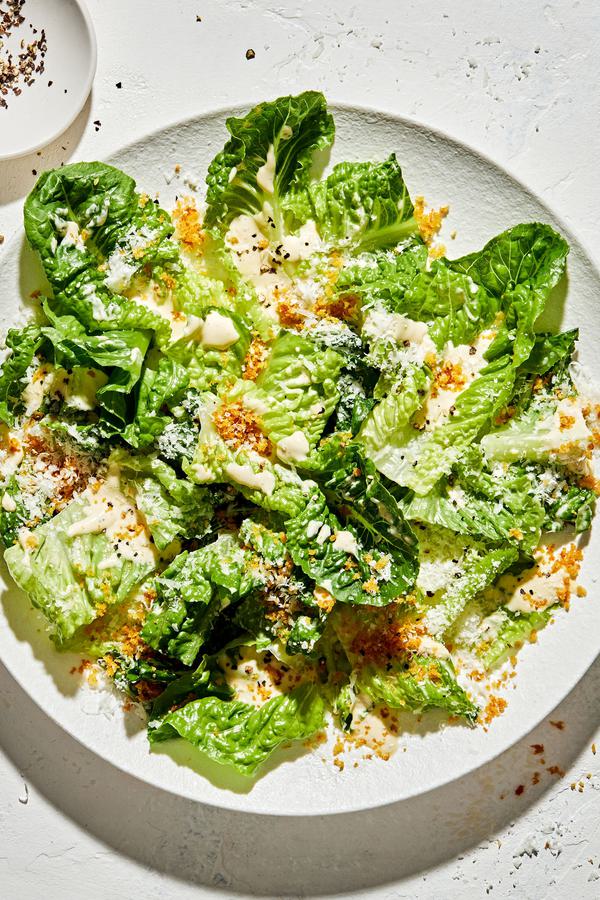 Caesar salad on a plate with homemade caesar dressing, toasted panko breadcrumbs and finely grated Parmesan cheese
