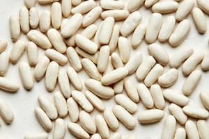 dried cannellini beans spread out on the counter