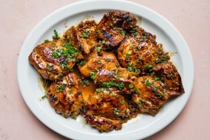 a platter of homemade chicken adobo sprinkled with green onions