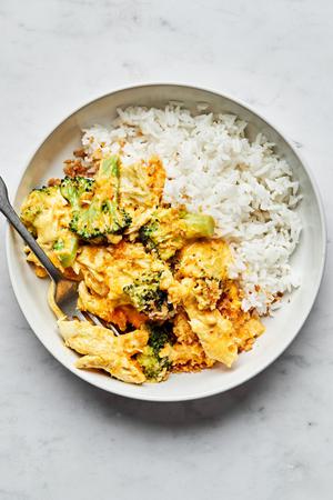 chicken divan made with chicken, broccoli, cheese and panko in a bowl served on top of white rice