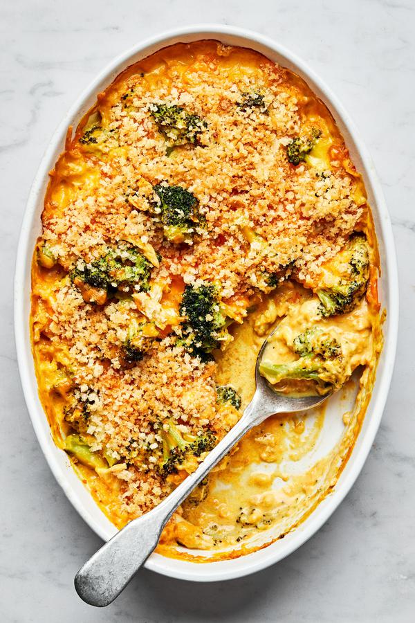 chicken divan in a casserole dish with a serving spoon made with chicken, broccoli, cheese and topped with panko