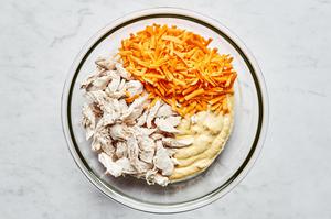 salt, cream of chicken soup, sour cream, milk, garlic & onion powders, curry powder, bouillon, chicken, & cheese in a bowl