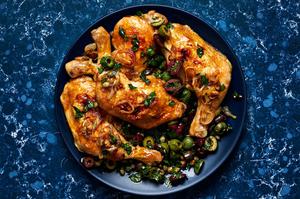 Chicken Quarters with Shallots and Olive Salad with capers, parsley, garlic & Italian seasoning on a serving platter