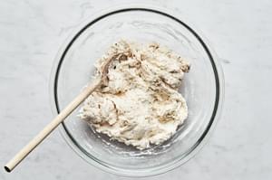 A bowl of homemade soft and fluffy biscuit dough, ready to be dropped into a pot of chicken and dumplings