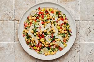 Chickpea salad tossed with homemade Italian dressing  and sprinkled with parmesan cheese in a serving bowl