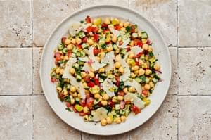 Chickpea salad tossed with homemade Italian dressing  and sprinkled with parmesan cheese in a serving bowl