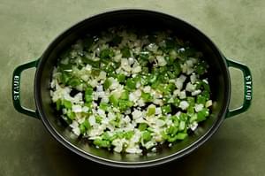 chopped onion, bell peppers and garlic being cooked in vegetable oil in a pot to use in chipotle chicken soup