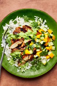 A homemade Citrus Chicken Rice Bowl with Ginger Jalapeño Sauce with a fork