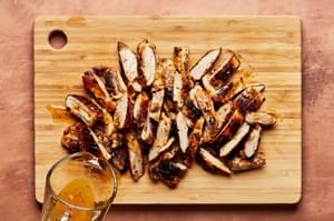 sliced citrus chicken on a cutting board for citrus chicken rice bowls with ginger jalapeño sauce