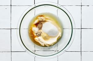 mayonnaise, sugar, apple cider vinegar, lemon juice and spices in a glass bowl to make coleslaw dressing