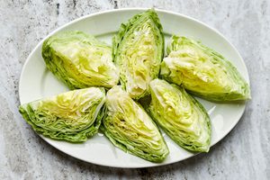a platter with 6 wedges of iceberg lettuce on it