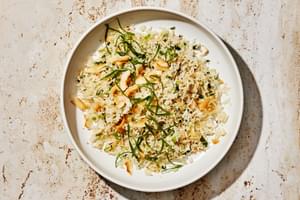 a bowl of homemade coconut fried rice made with coconut rice, green onions, ginger, coconut oil and sweetened coconut flakes