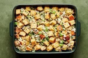 cornbread stuffing in a casserole dish ready to be baked in the oven