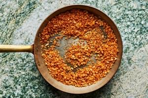 panko being cooked in butter in a skillet