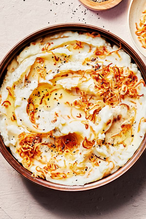 a bowl of homemade crispy shallot mashed potatoes made with butter, milk, garlic powder and salt