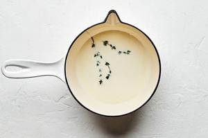 homemade béchamel sauce in a pot made with milk, butter, flour, dijon, fresh thyme, salt and nutmeg