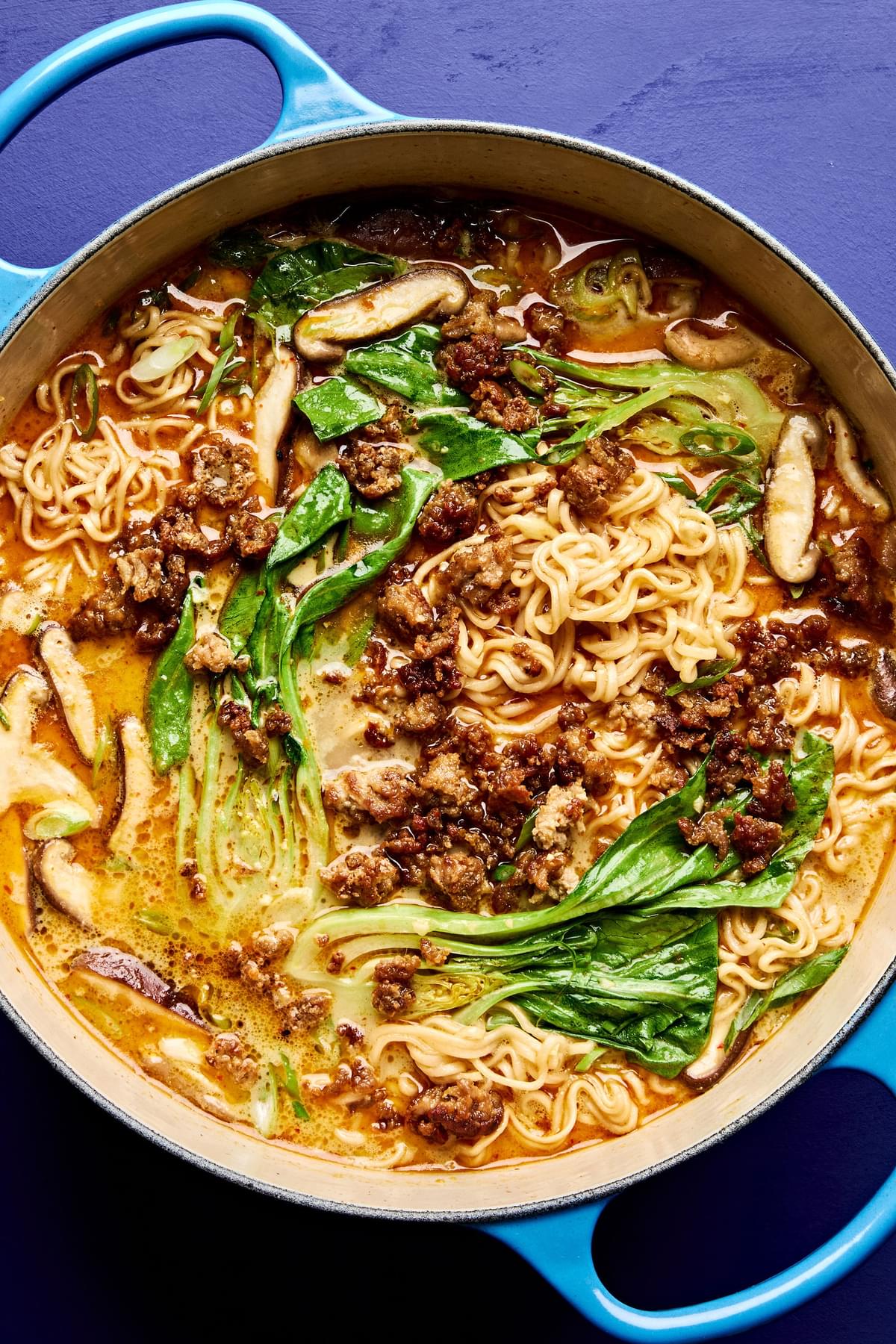 A pot of easy curry ramen with noodles, and vegetables submerged in a golden curry broth