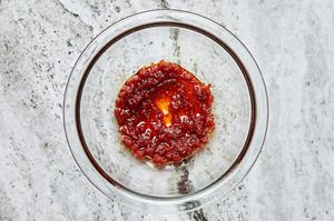 Red curry paste, lime juice in a small bowl