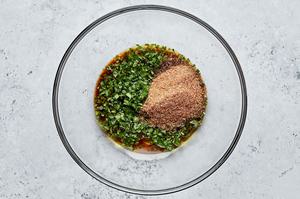 olive oil, lime juice, taco seasoning, soy sauce, and cilantro in a glass bowl to use for steak fajitas marinade