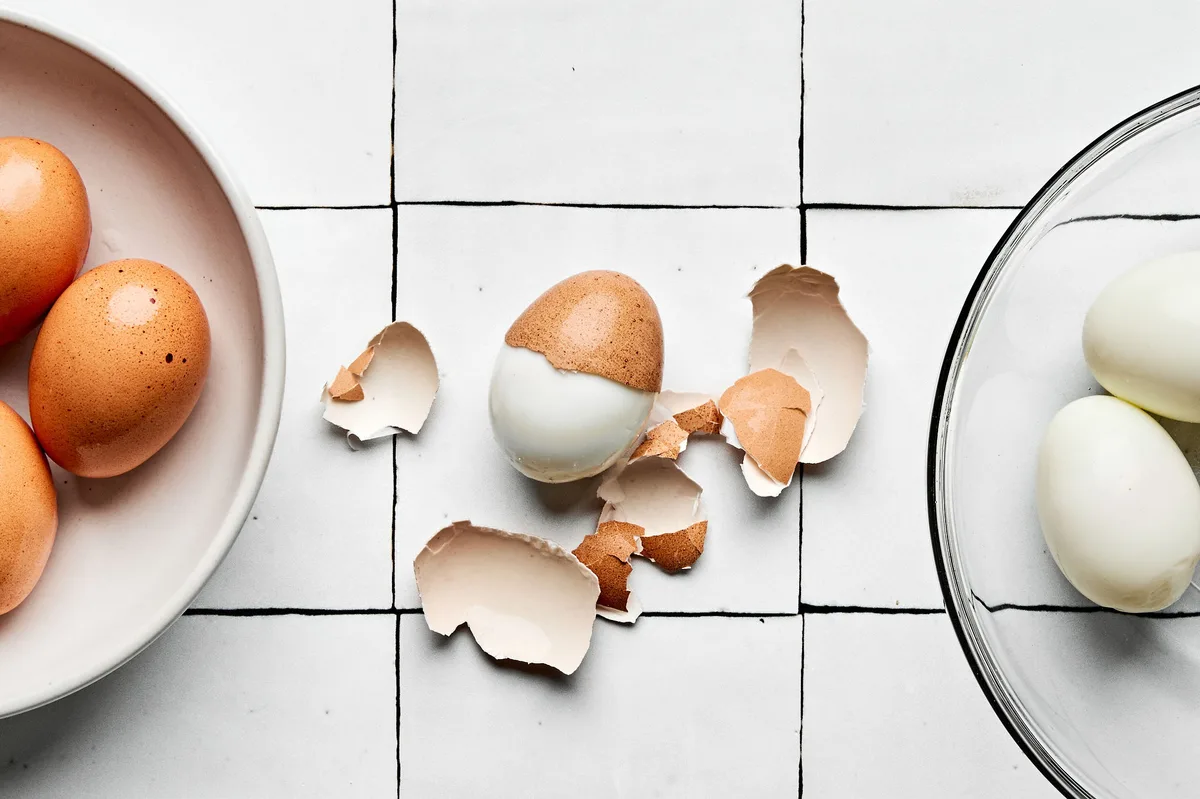 hard boiled eggs being peeled to use to make egg salad sandwiches