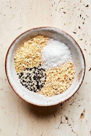 dried minced garlic, dried minced onion, salt and sesame seeds together in a bowl to make homemade everything bagel seasoning