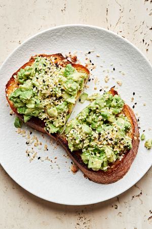 homemade everything bagel seasoning sprinkled on top of a piece of avocado toast on a plate