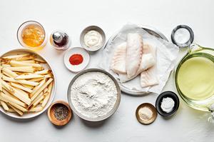 potatoes, pale ale flour, baking powder, salt, cayenne, garlic, oil, cod and pepper in bowls to make homemade fish and chips