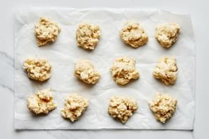 cobbler dough divided into 12 equal biscuits on parchment paper to make fresh berry cobbler