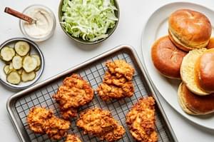 fried chicken, brioche buns, garlic aioli, sliced pickles and shredded iceberg lettuce for making fried chicken sandwiches