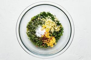 parsley, mint, garlic, olive oil, salt, lemon zest, lemon juice and crushed red pepper in a mixing bowl for gremolata