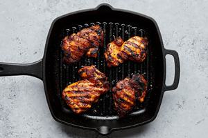 chicken thighs marinated in brown sugar, salt, garlic & onion powder, paprika, pepper & olive oil being grilled