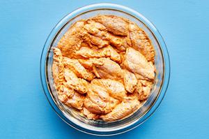raw chicken wings coated in lemon pepper spice rub then tossed in lemon pepper sauce