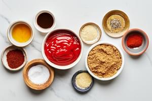 ketchup, brown sugar, apple cider vinegar, Worcestershire, chili powder, salt, garlic, powder, paprika and pepper in bowls