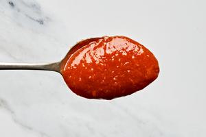 a spoonful of homemade cocktail sauce made with ketchup, horseradish, Worcestershire, Dijon, Tabasco, applesauce & lemon zest