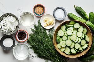 sweet onion, cucumbers, dill, garlic, mustard seed, peppercorn, white vinegar, distilled water sugar and salt on the counter