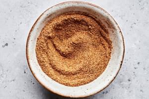 homemade old bay seasoning in a bowl made with celery salt, paprika, cayenne, dry mustard, nutmeg, cinnamon, and ginger