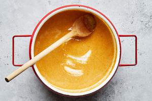 melted butter, flour, garlic and onion powders being stirred in a large sauce pan to make gravy for homemade poutine recipe