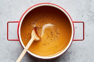 homemade gravy in a saucepan for poutine made with chicken and beef broth butter, flour, garlic and onion powders