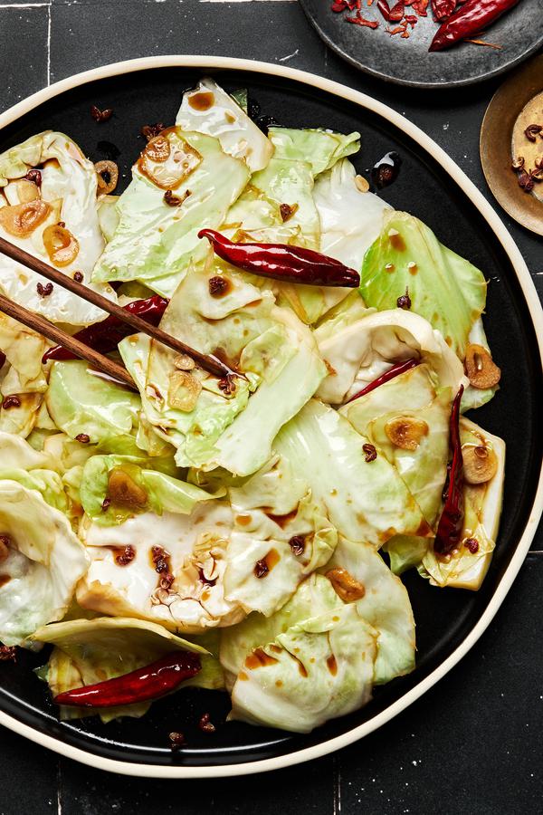 homemade hot and sour cabbage on a serving plate made with soy sauce, sugar, salt, sesame oil, garlic and Sichuan peppercorns