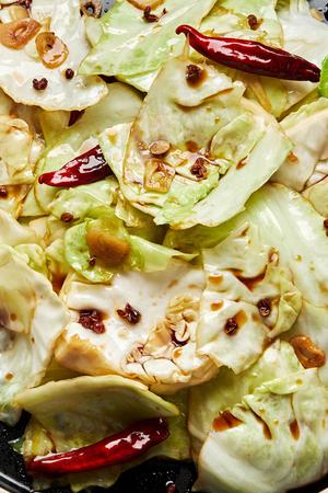 homemade hot and sour cabbage on a serving plate made with soy sauce, sugar, salt, sesame oil, garlic and Sichuan peppercorns