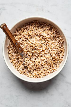 homemade farro in a serving bowl with a spoon