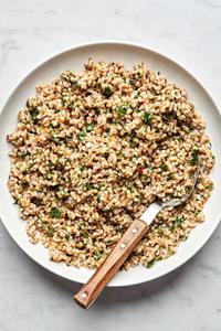 homemade farro in a serving bowl with a spoon